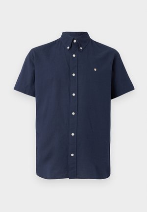 Kortermet marineblå skjorte laget av bomull, med knapper på kragen, frontknapper og en liten brodert logo på brystet.