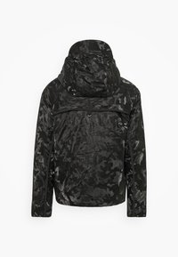 Black and dark gray camo-patterned hooded jacket shown from the back with long sleeves and a horizontal seam across the upper back.