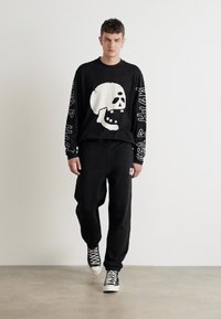 HUGO DLOGOPANTE - Spodnji deli trenirk - black