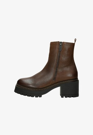 Brown leather ankle boot with side zipper, round toe, and chunky black heel. Features textured material and contrasting stitching detail.