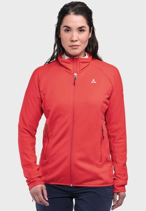 Rote Zip-Jacke mit hohem Kragen, geripptem Textil und seitlichen Taschen. Mit einem kleinen Logo auf der oberen linken Seite. Glattes Material.