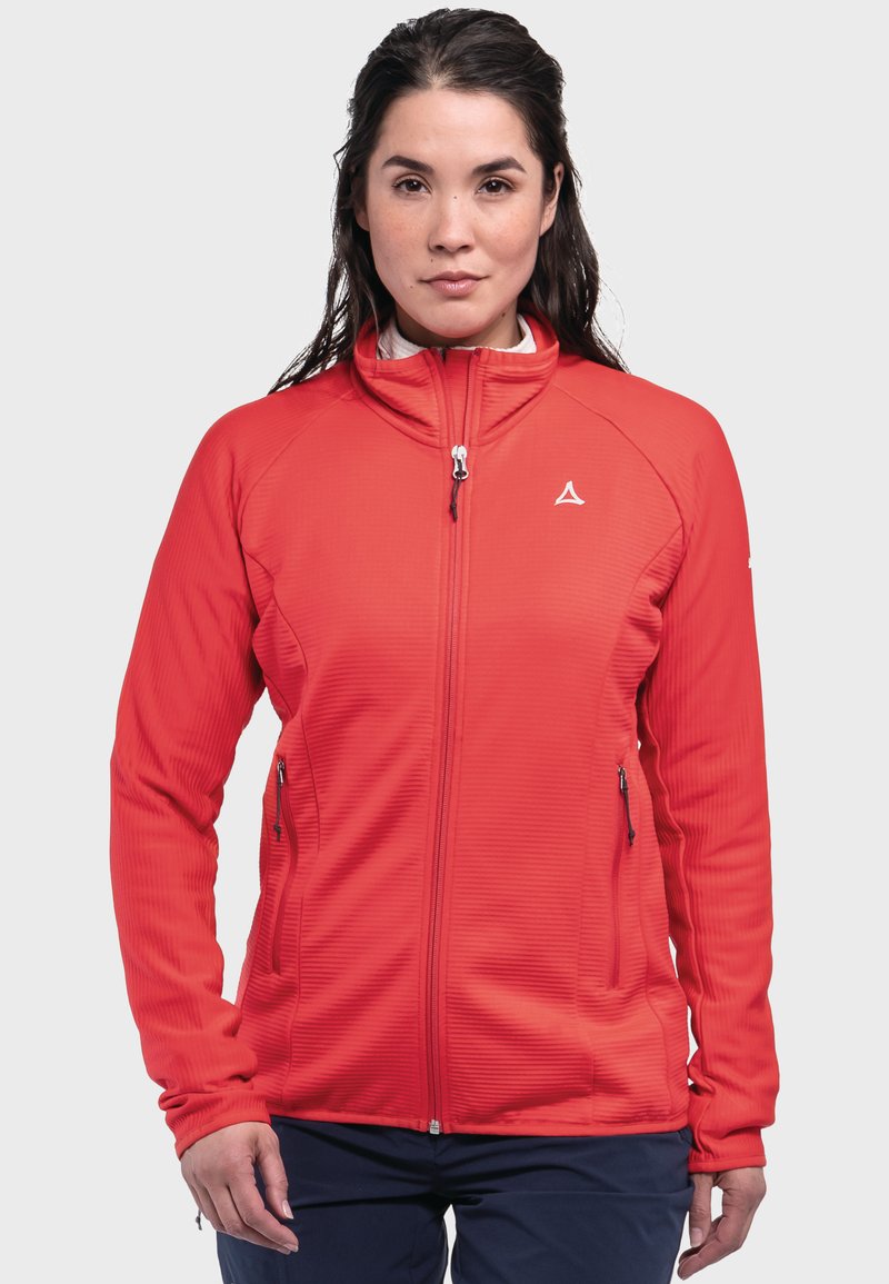 Rote Zip-Jacke mit hohem Kragen, geripptem Textil und seitlichen Taschen. Mit einem kleinen Logo auf der oberen linken Seite. Glattes Material.