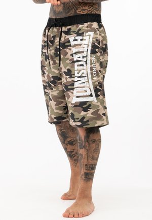 Camouflage swim shorts featuring a black elastic waistband, drawstring, and white "Lonsdale London" text on the side.