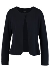 Musta bleiseri, jossa pyöreä pääntie, avoin edusta ja pitkät hihat. Valmistettu sileästä kankaasta; siinä on minimaalinen saumaus ja jäsennelty siluetti.