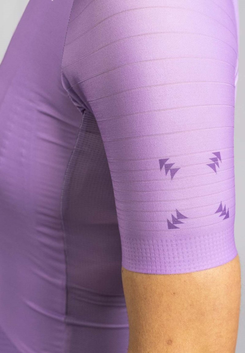 Short-sleeve athletic shirt in light purple with textured stripes and patterned accents on the sleeve, featuring a smooth, stretchy fabric.