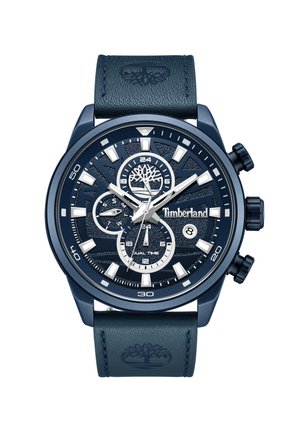 Montre chronographe bleu marine avec un cadran texturé, des accents argentés et un bracelet en cuir arborant un logo d'arbre. Affiche l'heure double avec plusieurs sous-cadrans.