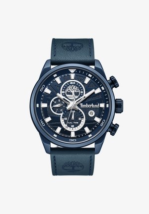 Orologio cronografo blu scuro con quadrante texturizzato, accenti argentati e cinturino in pelle con logo ad albero. Mostra il doppio fuso orario con diversi sub-quadranti.