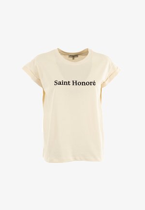 T-shirt in cotone color crema con maniche corte arrotolate e la scritta "Saint Honoré" stampata in grassetto nero sul davanti.