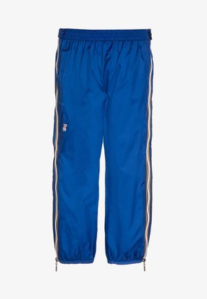 Pantalon de sport bleu avec ceinture élastique, fermetures éclair latérales sur toute la longueur des jambes et un petit logo sur la cuisse gauche.