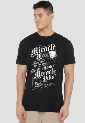 Black T-shirt with white graphic text featuring "Miracle Max" and "Miracle Pills!" in various fonts; short sleeves and round neckline.