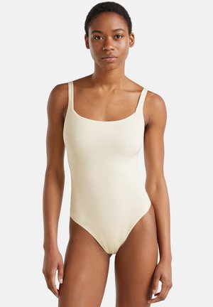Maillot de bain une pièce jaune clair avec bretelles réglables, encolure carrée et tissu lisse et extensible pour le confort. Design épuré et minimaliste.