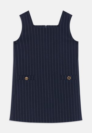 Navy dress with white vertical stripes, square neckline, two front pockets, gold hardware accents, made of a smooth fabric.