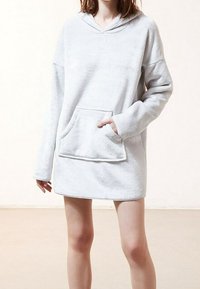 Light gray, hooded pullover made of soft fabric, featuring a front pocket and long sleeves, with a relaxed fit that falls above mid-thigh.
