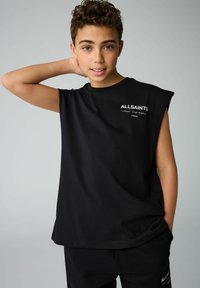 Must ülikondadega must särgita, mis on valmistatud puuvillast. Ees on valge "ALLSAINTS" logo ja tekst. Lõdva sobivuse ja pehme tekstuuriga.