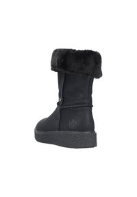 Bottines en cuir noir avec un revers en fausse fourrure, semelle texturée et un simple détail de couture sur le côté. Bout arrondi et logo sur le talon.