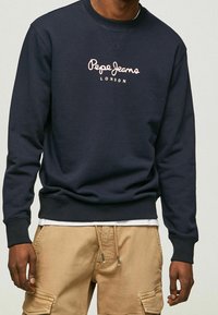 Navy blue sweatshirt in cotton blend, featuring a pink logo "Pepe Jeans London" on the front, ribbed neckline, cuffs, and hem.