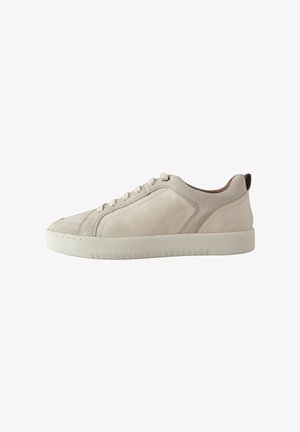 White leather sneaker with a smooth texture, low-horizon design, rounded toe, flat laces, and subtle stitching details on the sides.