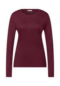 Bordowa koszulka z długim rękawem wykonana z miękkiej bawełny. Posiada okrągły dekolt i dopasowany fason z minimalną ilością szwów.