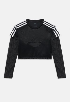 Black cropped athletic top with black patterned long sleeves, three white stripes on shoulders, and a subtle black logo at the center.