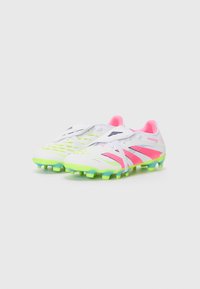 Soccer cleats featuring a white synthetic upper with bright pink and neon green accents, textured pattern, and a multi-coloured rubber outsole.