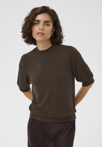 Brown knitted pullover with a round neckline and short, slightly puffed sleeves. The fabric appears soft and texture is smooth.