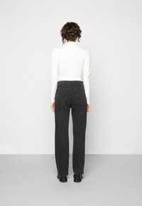 Svarta högmidjade jeans i denim, med en rak bendesign, fem fickor och en klassisk knappstängning fram.