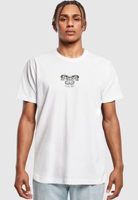 White cotton T-shirt featuring a central black graphic with the phrase "GIVE YOURSELF TIME" and a butterfly design. Casual fit and short sleeves.