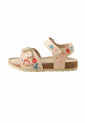 Beige children's sandal with cork sole, ankle and toe straps, embroidered colorful flowers, and gold buckle closure on toe strap.