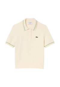 Polo a maniche corte in cotone crema con texture a costine, presenta un colletto a righe multicolore e una chiusura con tre bottoni. Logo Lacoste sul petto.