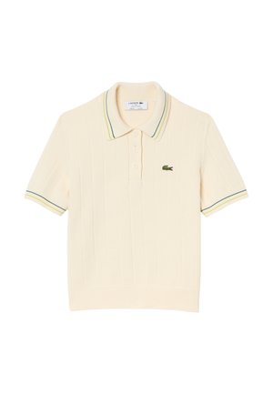Polo a maniche corte in cotone crema con texture a costine, presenta un colletto a righe multicolore e una chiusura con tre bottoni. Logo Lacoste sul petto.
