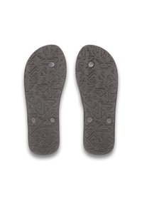 Grå gummisko soles med tekstureret mønster og cirkulært hardware, der viser et symmetrisk design velegnet til fritidssko.