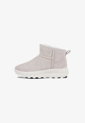 Light grey suede ankle boot with a soft, white faux fur lining, textured white rubber sole, and a rear pull tab for easy wear.