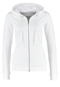 Sudadera blanca con cremallera y capucha ajustable, mangas largas, bolsillos frontales y puños acanalados. Hecha de suave tejido de algodón.