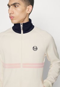Sergio Tacchini DALLAS TRACK - Jaka ar rāvējslēdzēju - gardenia/maritime blue