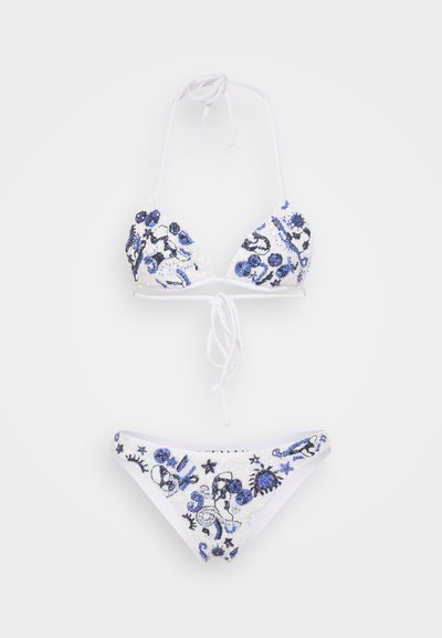 White bikini set featuring triangular top and low-rise bottoms. Decorated with blue and black embroidered designs and sequins.