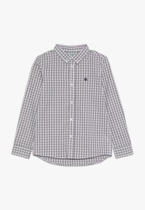 Long-sleeve, black and white checkered button-up shirt with a collar and small black logo on the left chest.