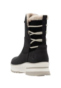 Black waterproof boot with textured upper, cream faux fur lining, and contrasting lace detail on the back. White chunky sole.