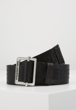 Black fabric belt with embossed logo pattern and silver rectangular buckle engraved with "KARL LAGERFELD," displayed on white surface.