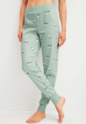 Pantaloni da pigiama verde chiaro realizzati in tessuto morbido, con un motivo di gatti bianchi su pattini da ghiaccio, con polsini aderenti e vita elasticizzata.