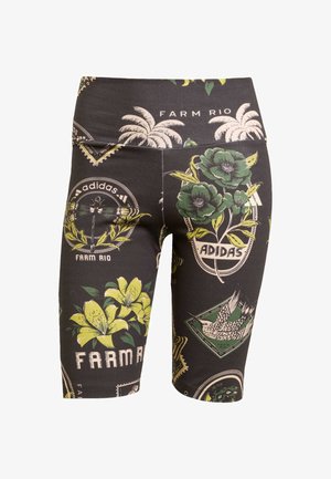 Svarta cykelbyxor med ett livligt blommönster och grafiskt mönster i grönt, gult och vitt, med en bred midja som visar "FARM RIO" och "ADIDAS."