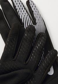 Black gloves with a textured grip, featuring a smooth white striped pattern on the back and black reinforcement on the fingertips.
