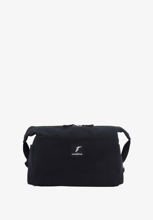 Black rectangular bag made of durable fabric with a zippered closure, featuring a small Goodyear logo patch on the front.