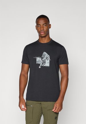 Black cotton t-shirt with a graphic print of a mountain and lines, crew neck, short sleeves, fitted design. Worn with green cargo shorts.