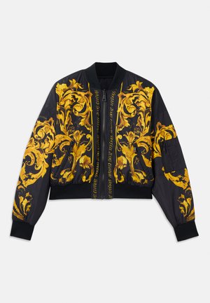 Veste bomber noire avec motif floral doré, poignets et ourlet côtelés, fermeture éclair et poches latérales. Présente un texte de logo sur le devant.