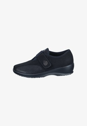 Black athletic shoe with a mesh upper and suede accents, featuring a Velcro strap, rounded toe, and textured rubber sole.
