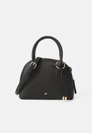 Black textured leather handbag with double handles, adjustable shoulder strap, gold hardware, and decorative tied leather cords on a white background.