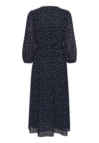 Robe à pois bleu marine avec un design fluide ; possède des manches ballons, une taille cintrée et une texture légère et transparente.