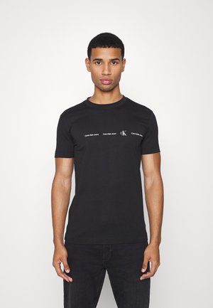 REPEAT LOGO TEE UNISEX - Camiseta estampada - black