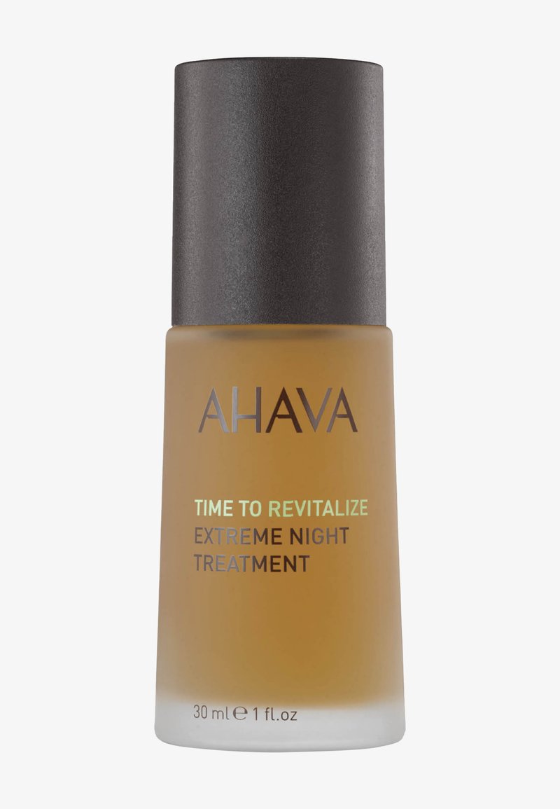 Flaske med AHAVA Time to Revitalize Extreme Night Treatment serum, 30 ml, med frostet ravfarvet glas og sort låg.