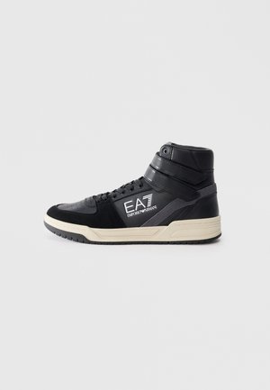 Black high-top sneaker made of leather and suede with a rubber sole. Features logo branding and contrasting textures on the upper.